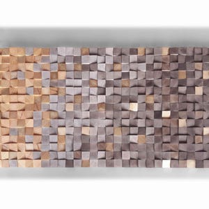 a large, rectangular, and textured surface composed of numerous small, square-shaped wooden blocks in various shades of brown and gray. The blocks are arranged in a grid-like pattern, creating a visually striking and intricate design.