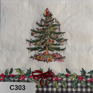 May include: A white paper napkin featuring a central illustration of a decorated Christmas tree with gifts underneath, marked with the text Spode. The bottom border displays a black and white checkered pattern with green holly leaves, red berries, and a red bow.