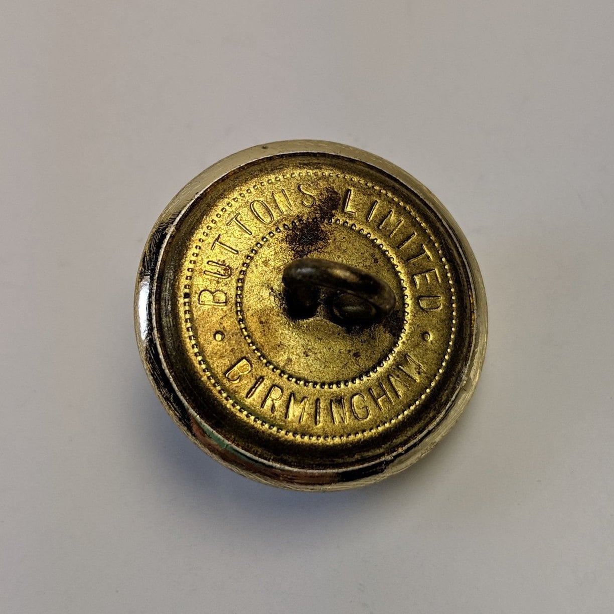 Brass button with crown reverse has I.C.M.