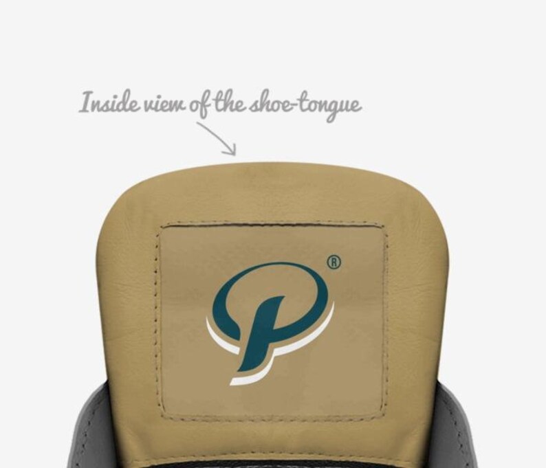 May include: Inside view of a shoe tongue with a tan leather surface and a square patch with a teal blue and white logo of a stylized letter "P" with a registered trademark symbol.