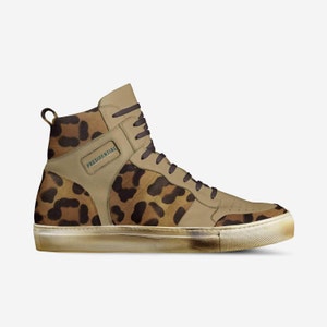 May include: High-top sneakers with a leopard print design and a gold-colored sole. The shoes have a brown leather upper with a green "PRESIDENTIAL" label on the side.