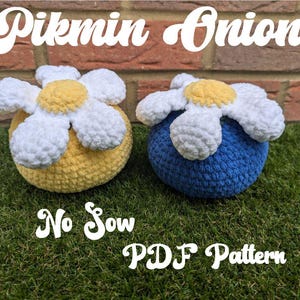 May include: Two crocheted Pikmin Onion plush toys. One is yellow with a white flower on top and the other is blue with a white flower on top. The text "No Sow PDF Pattern" is below the toys.