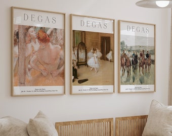 May include: Three framed prints of Degas artwork, featuring dancers and a horse race, hang on a white wall above a light beige couch with pillows. A wooden coffee table with a black origami bird and a potted plant sits in front of the couch.