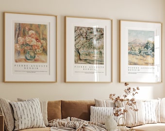 May include: A brown sectional sofa with a throw blanket and pillows in a living room with three framed art prints featuring paintings by Pierre-Auguste Renoir. The prints are hung on a light beige wall.