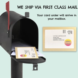 May include: A brown envelope with a white label that says "Jennifer Smith, 1572 MAIN STREET, WHEATON, IL 60187-5123" and a sticker that says "HOORAY! YOUR CARD ORDER IS ON ITS WAY!" The envelope is being placed in a black mailbox.