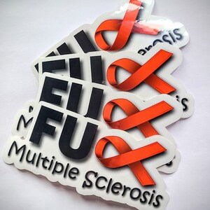 May include: Multiple stickers with the text "FU" and an orange ribbon. The ribbon is the symbol for Multiple Sclerosis. The stickers say "Multiple Sclerosis" at the bottom.