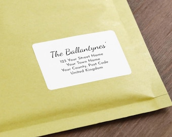 May include: A close-up of a light yellow envelope with a white label. The label features the text "The Ballantynes" in a script font, along with an address including a street name, town, county, and post code.