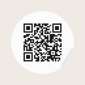 May include: A circular white sticker featuring a black QR code printed in the centre. The sticker has a smooth, matte finish and a clean, simple design, with the black and white pattern clearly visible against the solid white circular background.