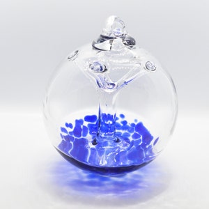 Blown Glass Witch Ball Ornament Deep Blue Speckles on Clear Background. Blown Glass Tree of Life Ornament