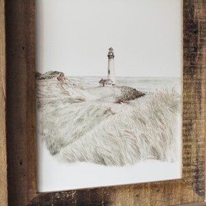 May include: A framed watercolor painting of a lighthouse on a grassy cliff overlooking the ocean. The lighthouse is white with a black roof and a small window. The grass is a light green color and the ocean is a light blue color.