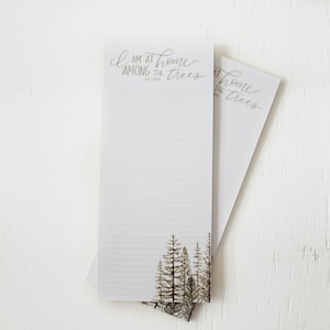 May include: Two white lined notepad sets with a forest scene and the text "I am at home among the trees" on the top of each notepad.