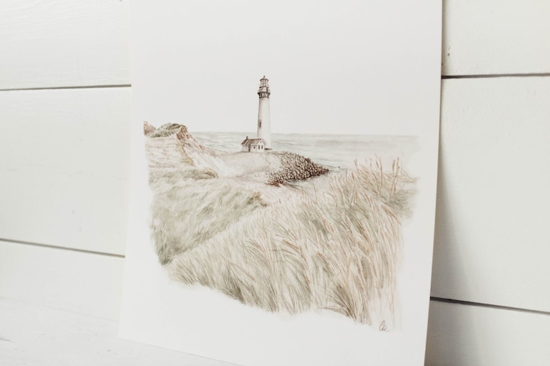May include: A watercolor painting of a white lighthouse on a rocky coast with tall grass in the foreground. The sky is a light blue and the ocean is a light gray.