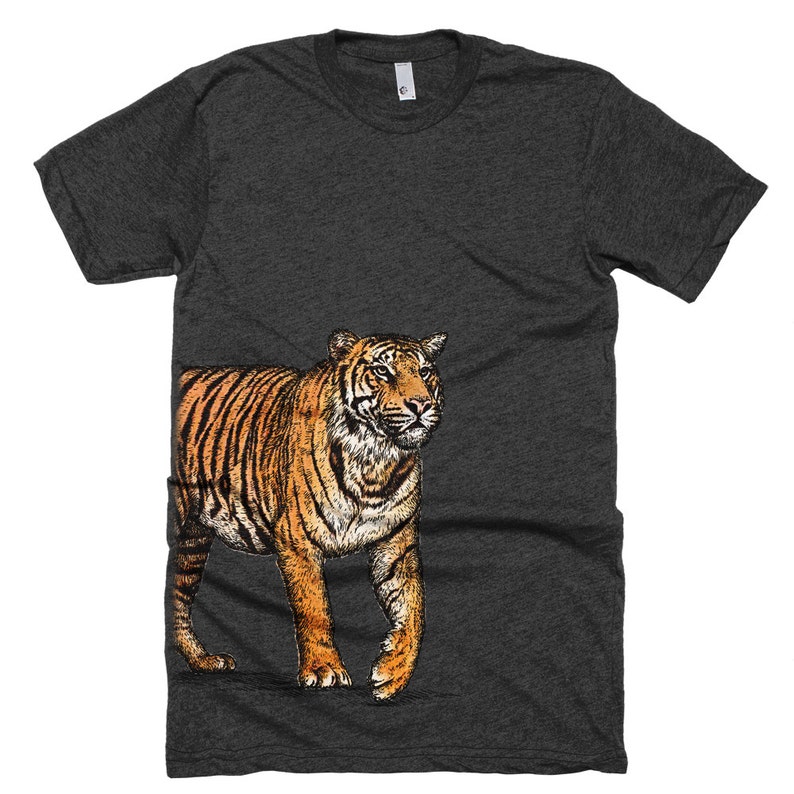May include: A dark heather grey t-shirt with a graphic of a tiger walking to the right. The tiger is orange and black with white stripes.