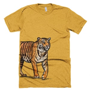 May include: A mustard yellow t-shirt with a black and orange illustration of a tiger on the right side of the shirt.