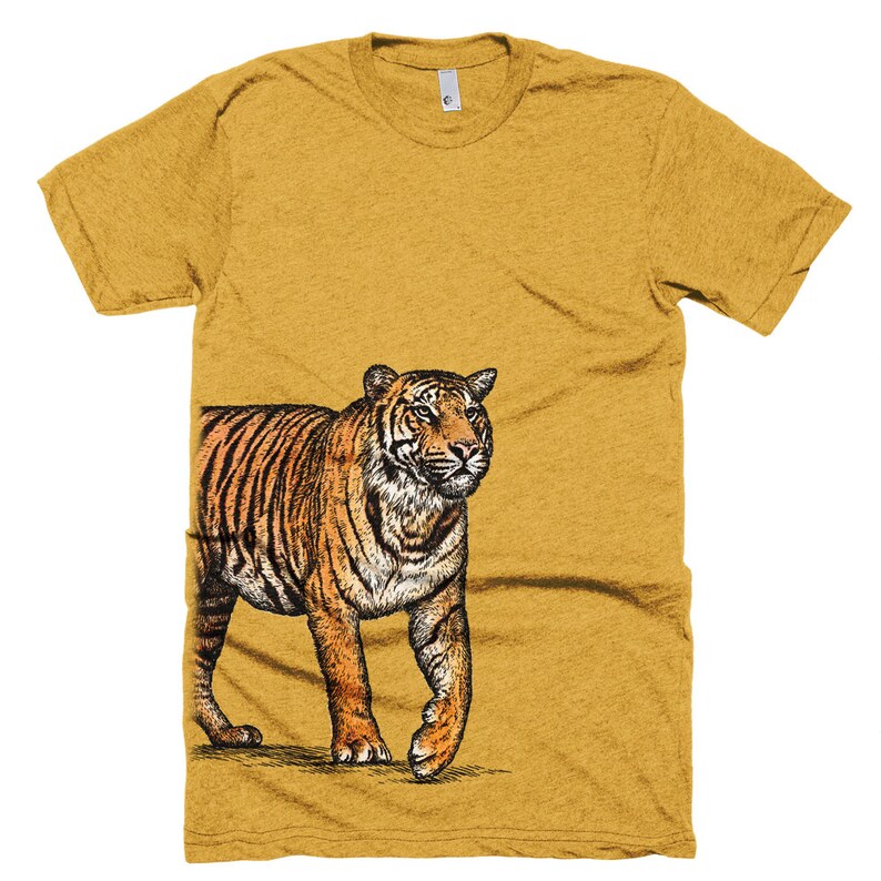 May include: A mustard yellow t-shirt with a black and orange illustration of a tiger on the right side of the shirt.