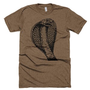 May include: A brown t-shirt with a black graphic of a cobra with its hood raised.