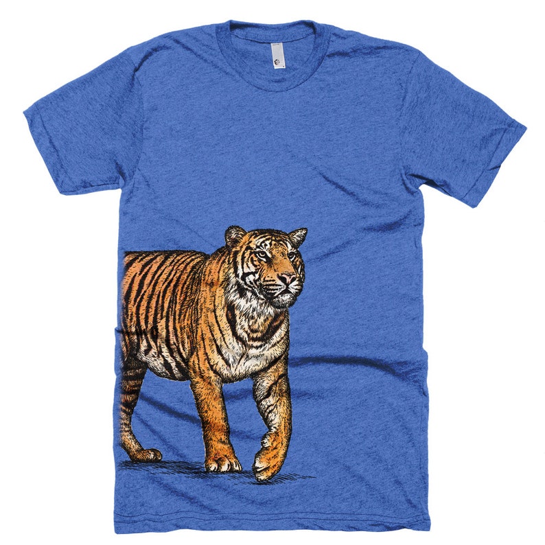 May include: A blue t-shirt with a graphic of a tiger walking to the right. The tiger is orange and black with white stripes.