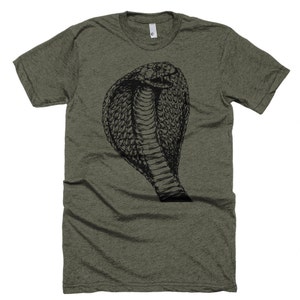 May include: A green t-shirt with a black and white illustration of a cobra snake with its hood raised.