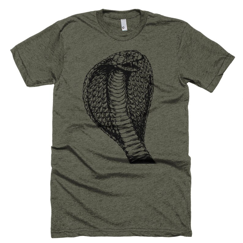 May include: A green t-shirt with a black and white illustration of a cobra snake with its hood raised.