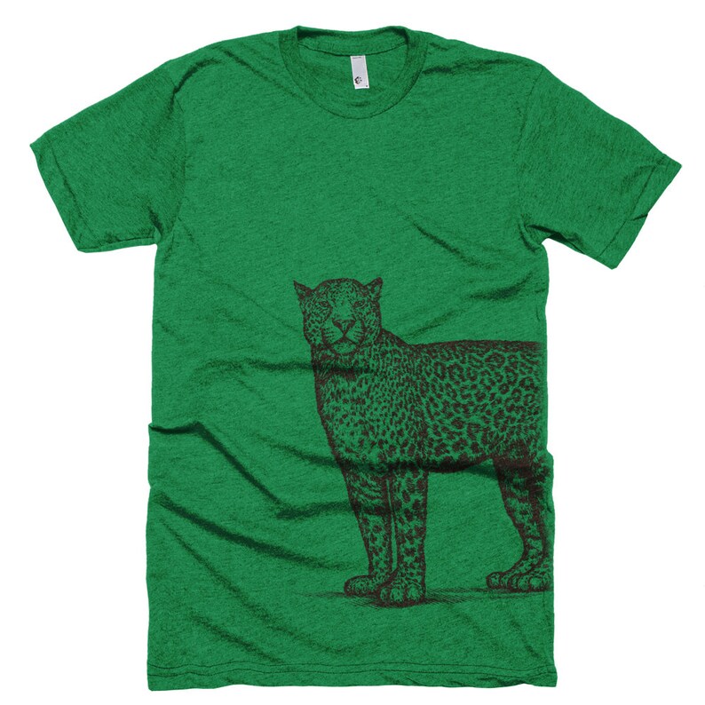 May include: A green t-shirt with a black and white illustration of a leopard on the right side of the shirt.