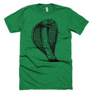 May include: A green t-shirt with a black and white illustration of a cobra snake with its hood raised.