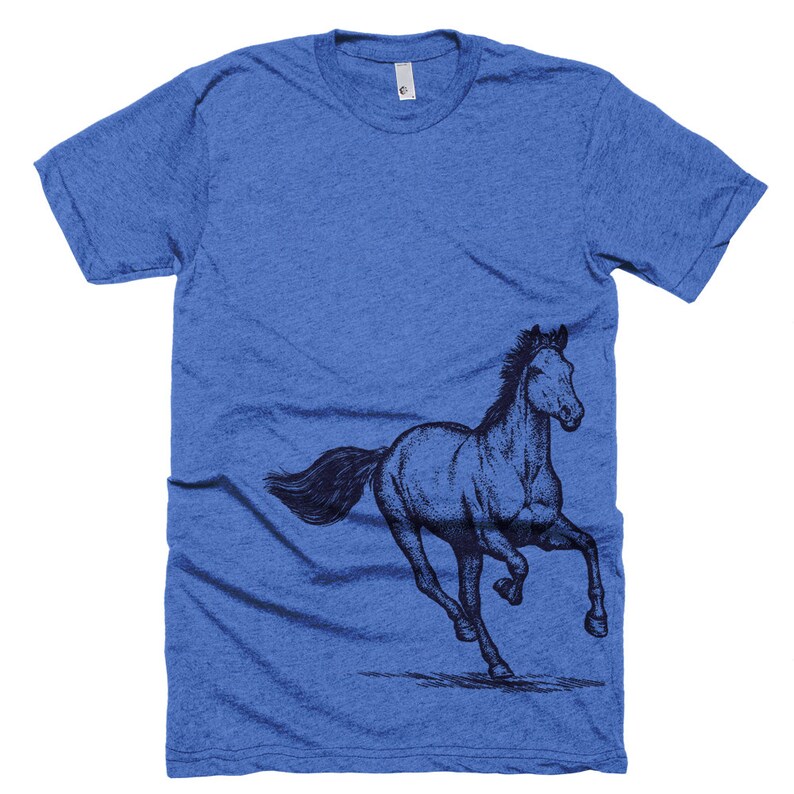 May include: A blue t-shirt with a black and white illustration of a horse running on the left side of the shirt.