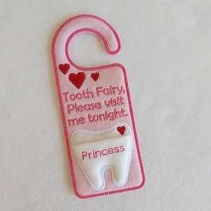 May include: Pink felt tooth fairy door hanger with a white felt tooth pocket and the text "Tooth Fairy, Please visit me tonight. Princess".