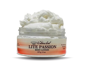 May include: A white jar of Untouched Lite Passion Body Lotion with a white, whipped cream-like texture on top. The jar is labeled with the product name and size: 227g | 8 oz.