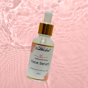 May include: A clear glass bottle of hyaluronic acid face serum with a white and gold cap and dropper. The label reads "Untouched" and "Face Serum". The background is a pink, rippled surface.
