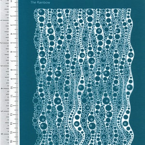 May include: A teal blue stencil with a white design of overlapping circles and wavy lines. The stencil is labeled "The Rainbow".