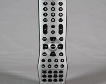 May include: A silver remote control with black buttons and a black and silver display. The remote has buttons for power, input, channel, volume, guide, enter, exit, and more. The remote is labeled "INSIGNIA".