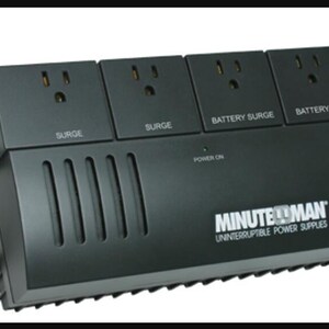 May include: Black surge protector with four outlets and a power button. The text "MINUTE MAN MN 325 UNINTERRUPTIBLE POWER SUPPLIES" is printed on the front.
