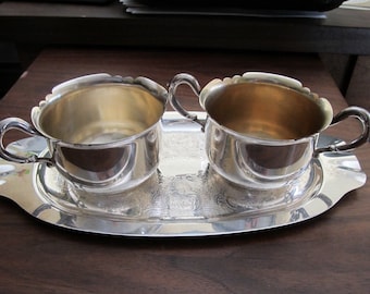Silver plate creamer and sugar on tray.  Elegant for the breakfast tray or table.  Light distress but 0ver 50 years and old very pretty!
