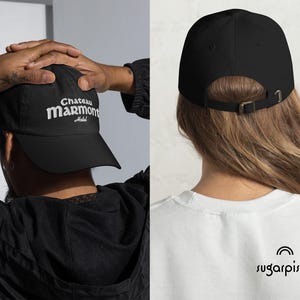 May include: Black baseball cap with white embroidered text that reads "Chateau Marmont Hotel".
