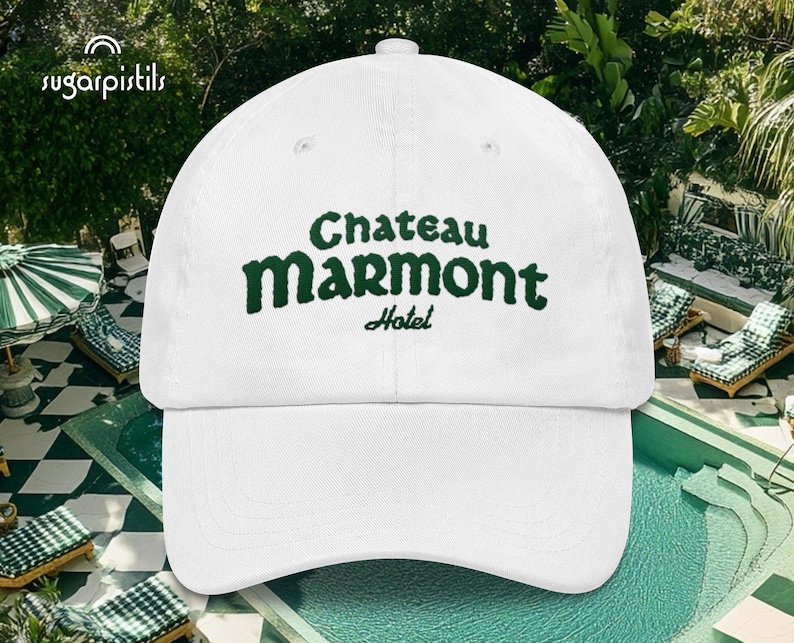 May include: White baseball cap with green embroidered text that reads "Chateau Marmont Hotel".