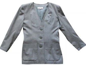 May include: A gray blazer with a v-neck and four buttons. The blazer has two flap pockets and a label that reads "Yves Saint Laurent" on the inside.