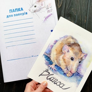 May include: A watercolor painting of a rat named Blanca. The rat is brown and white and is eating a piece of food. The painting is on a white background with the name Blanca written in black ink.