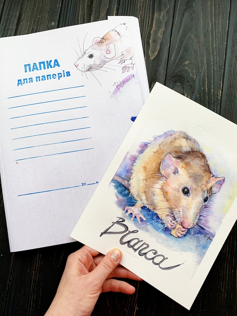 May include: A watercolor painting of a rat named Blanca. The rat is brown and white and is eating a piece of food. The painting is on a white background with the name Blanca written in black ink.