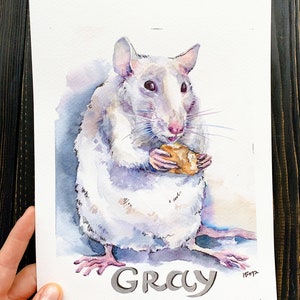 May include: Watercolor painting of a gray rat holding a piece of food. The rat is depicted in shades of gray, white, and purple, with pink feet and ears. The word "GRAY" is written in gray letters at the bottom of the painting.