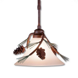 May include: A rustic pendant light with a white frosted glass shade and pine cone accents. The light fixture is made of metal and has a brown finish.