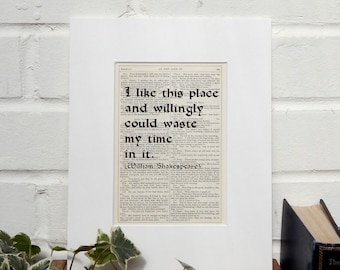 May include: A framed print of a vintage book page with a quote from William Shakespeare's play As You Like It. The quote reads "I like this place and willingly could waste my time in it."