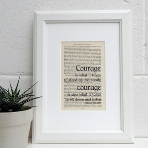 May include: A black and white print of a quote by Winston Churchill. The quote reads "Courage is what it takes to stand up and speak. Courage is also what it takes to sit down and listen."