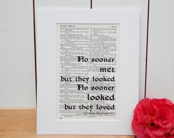 May include: A black and white print of a page from a book, featuring a quote from Shakespeare's play As You Like It. The quote reads "No sooner met but they looked, No sooner looked but they loved." The print is framed in a white frame.