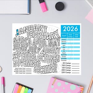 May include: A white and black 2026 calendar with the months of the year in a stylized font. The calendar includes a section for tracking goals and a blue section with the year 2026. The image is surrounded by office supplies.