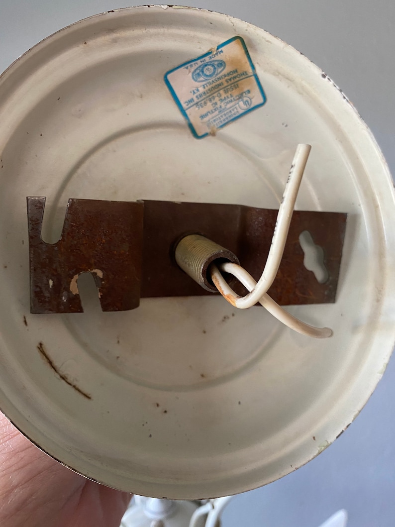 May include: White ceiling fixture with a metal bracket and two wires. The fixture has a label that reads "XTURE IC THOMAS INDUSTRIES INC HOPKINSVILLE, KY. MADE IN USA".