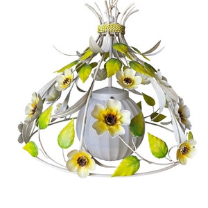 May include: White metal pendant light fixture with a white frosted glass globe shade. The fixture is decorated with yellow and green metal flowers.