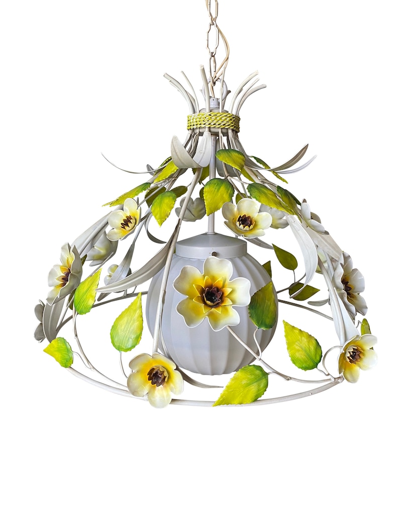 May include: White metal pendant light fixture with a white frosted glass globe shade. The fixture is decorated with yellow and green metal flowers.