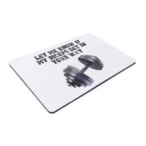 May include: White mouse mat with the text "Let me know if my biceps get in your way" and a black and silver dumbbell.