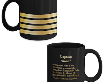 May include: Black coffee mug with a gold design of four horizontal stripes on one side and the definition of "Captain" on the other side. The definition reads: "someone who does precision guesswork based on unreliable data provided by those of questionable knowledge. See also: wizard, magician."
