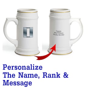 May include: White ceramic beer stein with a gold trim. The stein has a personalized message that reads "Captain John Williams October 8th 2022".